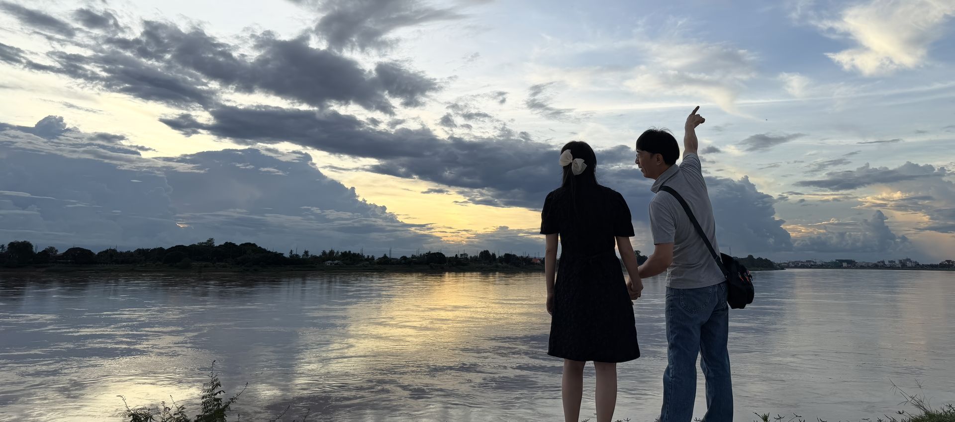 Couple by the Mekong at sunset